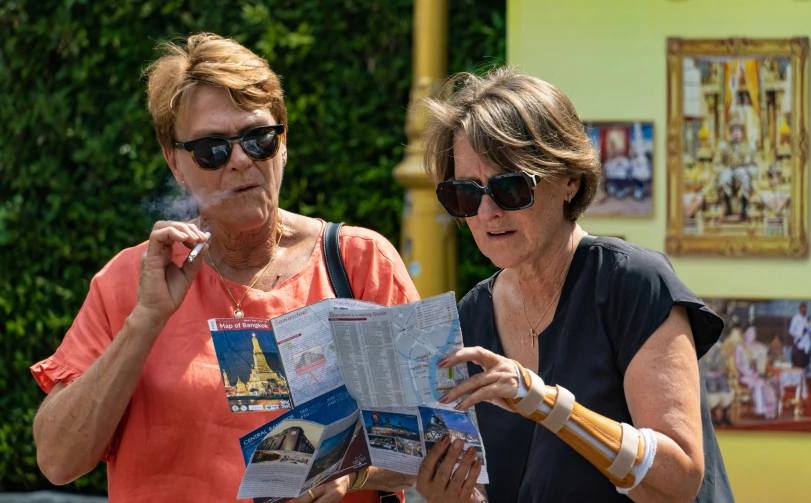 two women who are standing together and talking