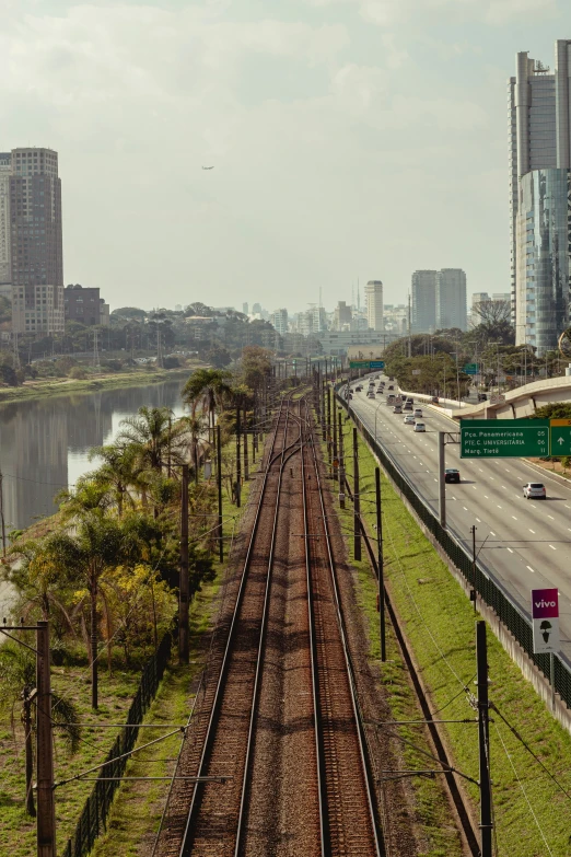 a large train track next to the highway and some buildings