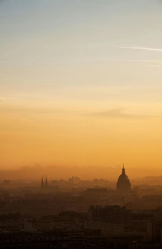 an image of a distant city at sunset