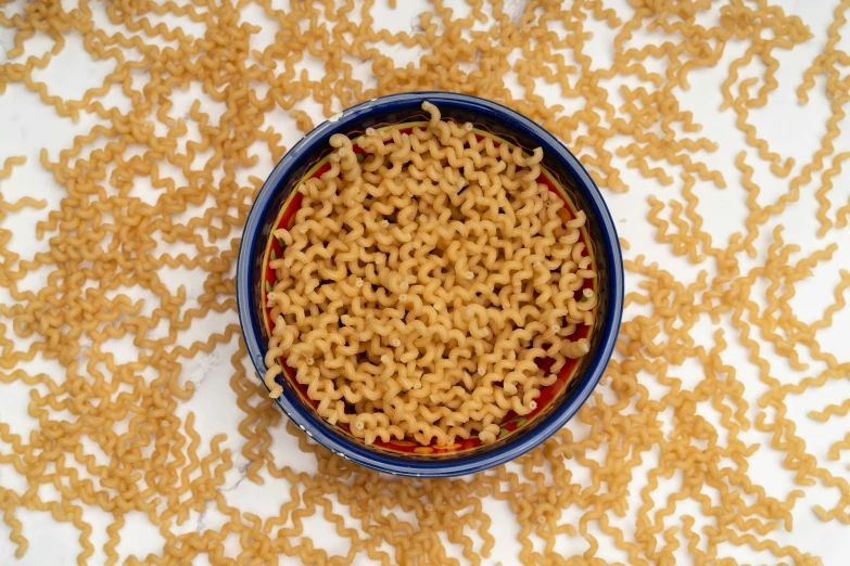 a bowl is filled with noodles and a spoon