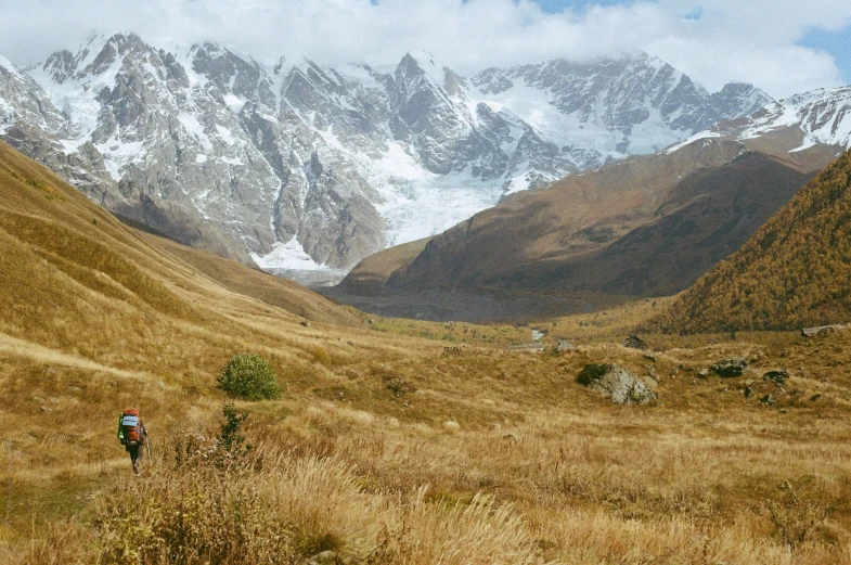 a person in a valley looking down on some mountains