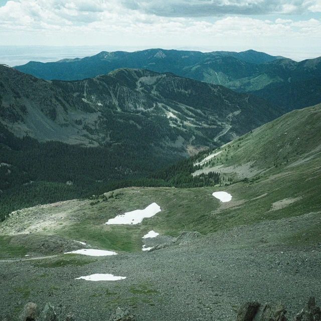 a mountain range with snow on the ground