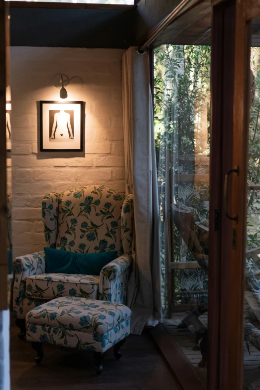 a living room with two chairs next to the wall