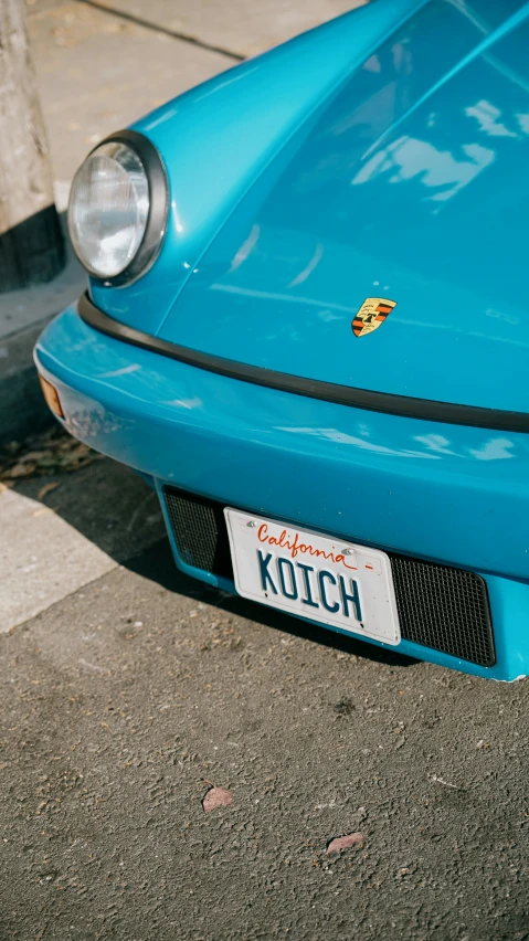 blue sports car parked next to the curb