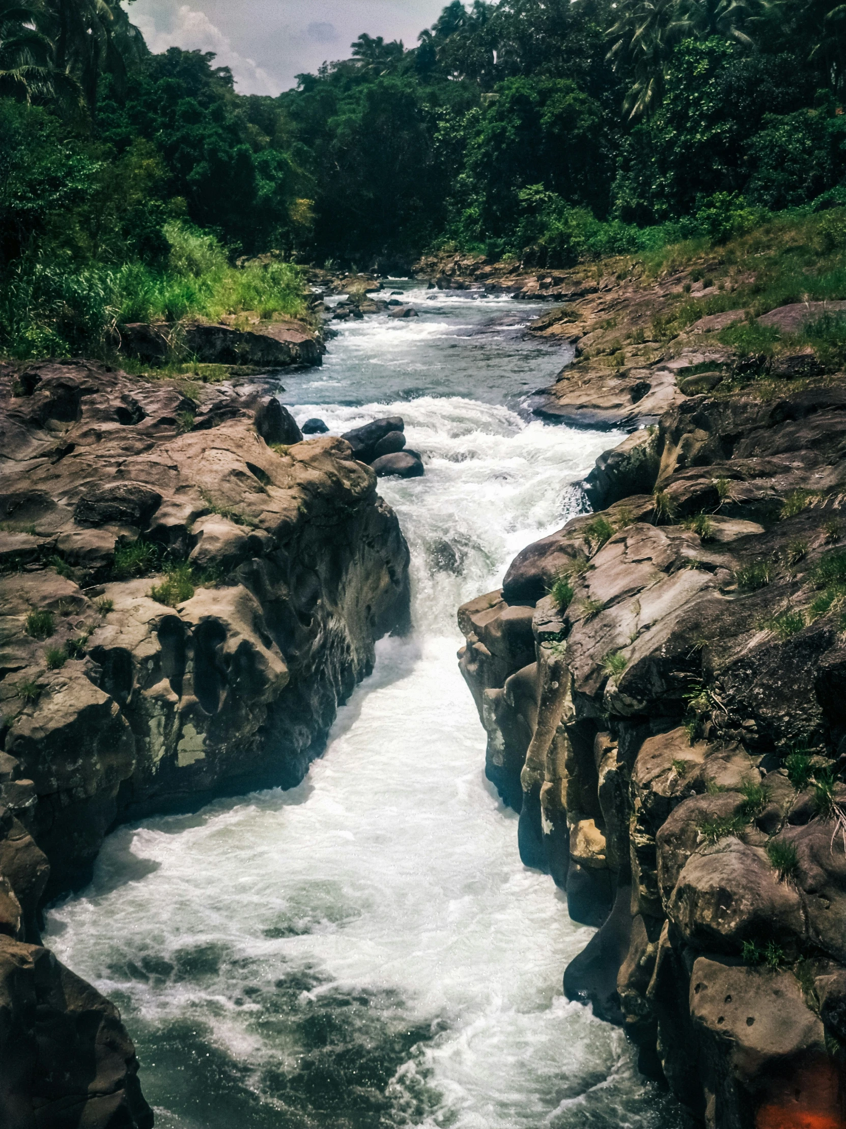 a river with many boulders next to it