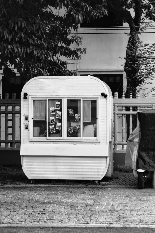 the small shack is painted white and has some windows