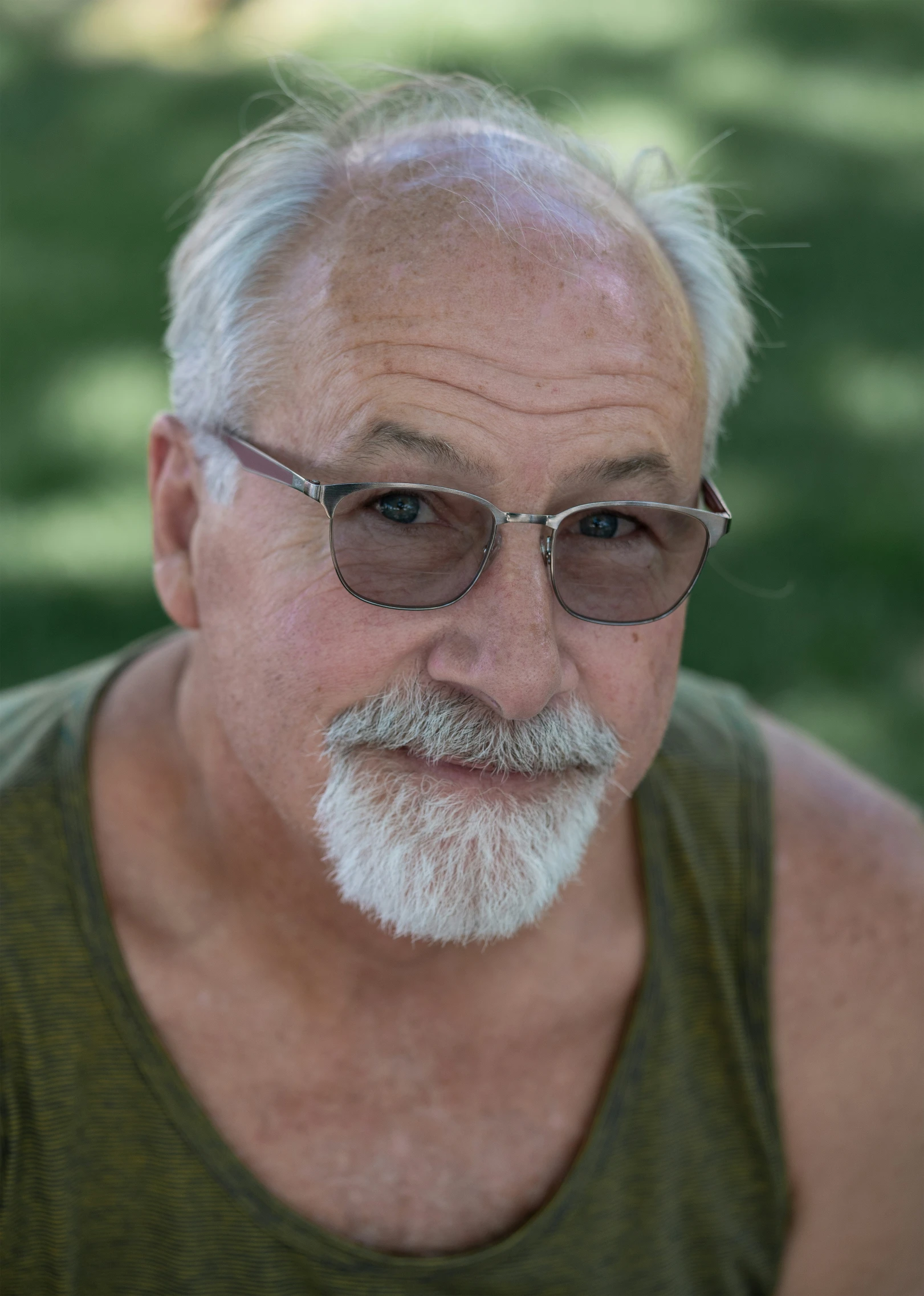 an older man with sunglasses looking up into the sky