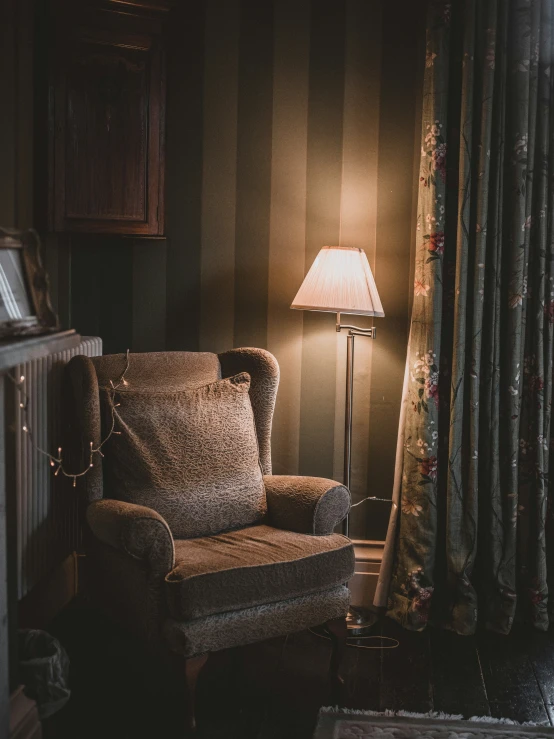 an old couch is lit by a lamp