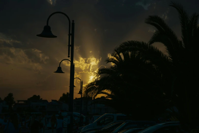 the setting sun shining through clouds and clouds above