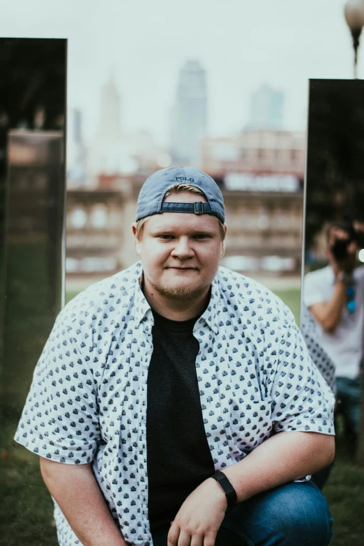 a person with a camera around his neck sitting