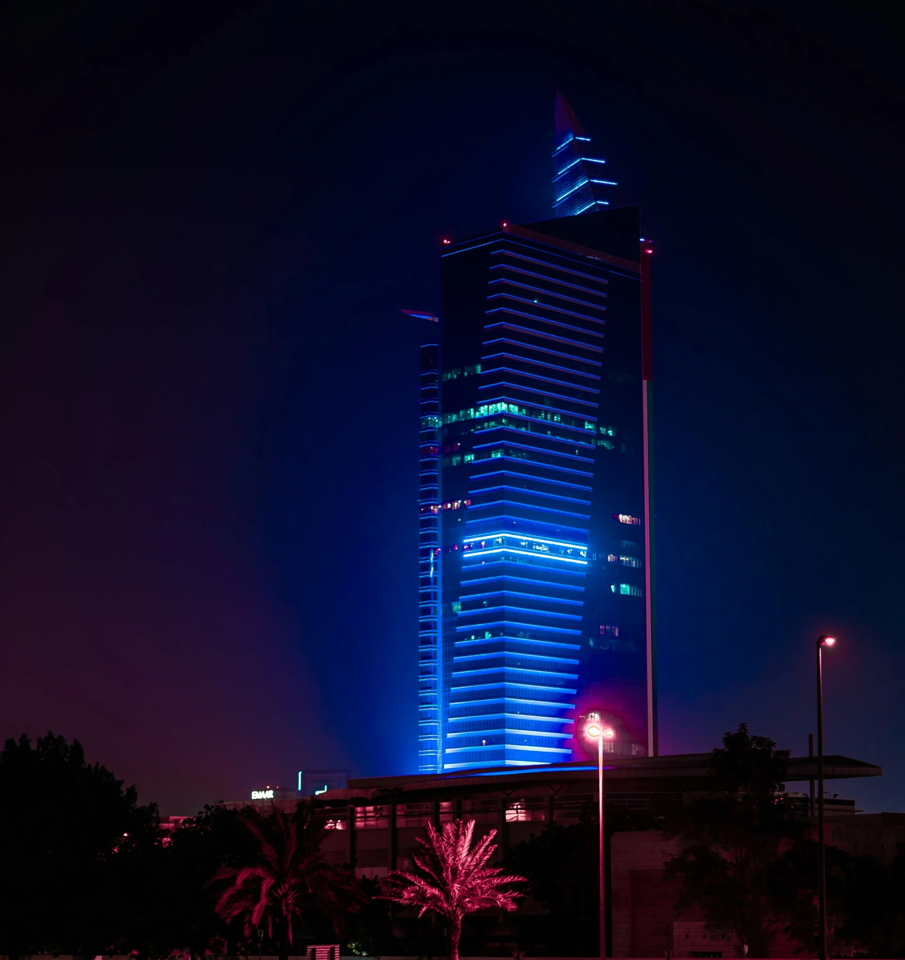 the large skyscr building is lit up brightly