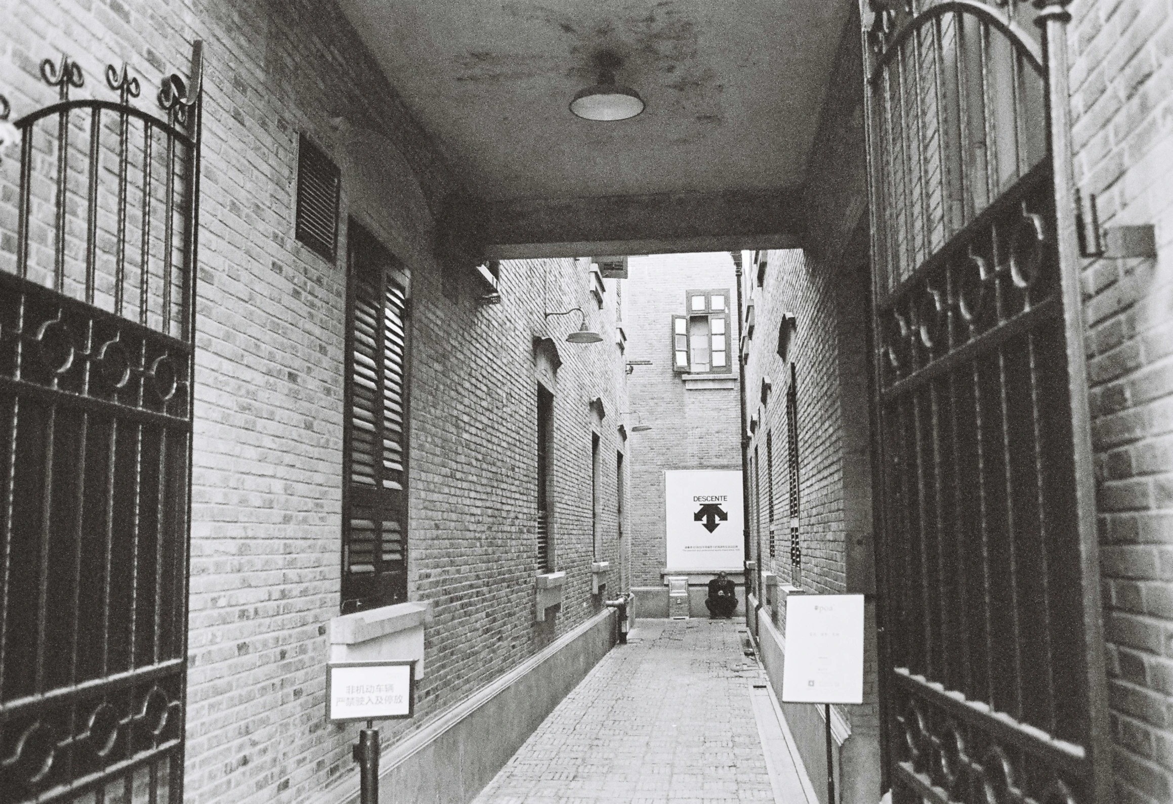 an alley that leads to the entrance of a  cell building