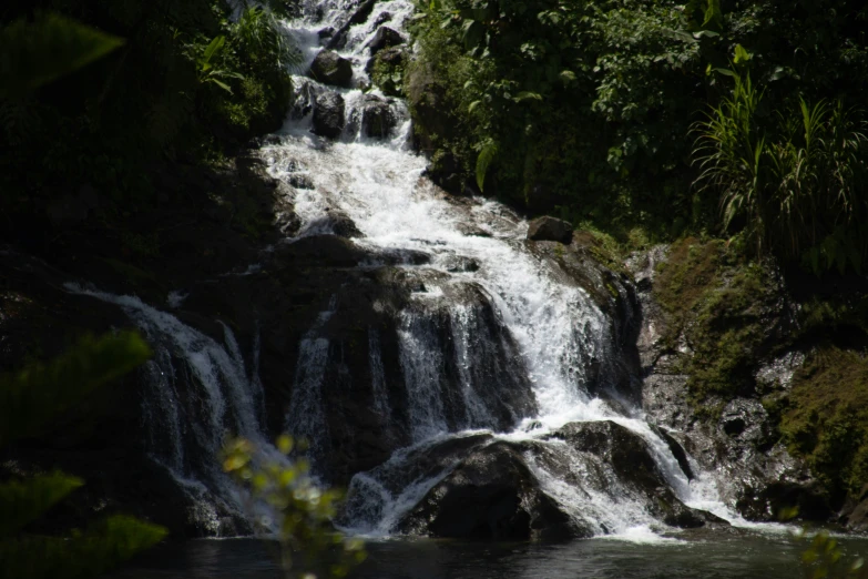 the water is falling off of a waterfall