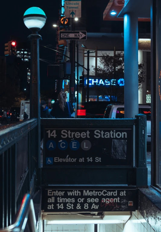 a bus stop in the city has several lit signs