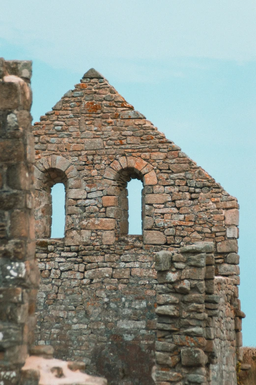 an old church made out of bricks under a blue sky