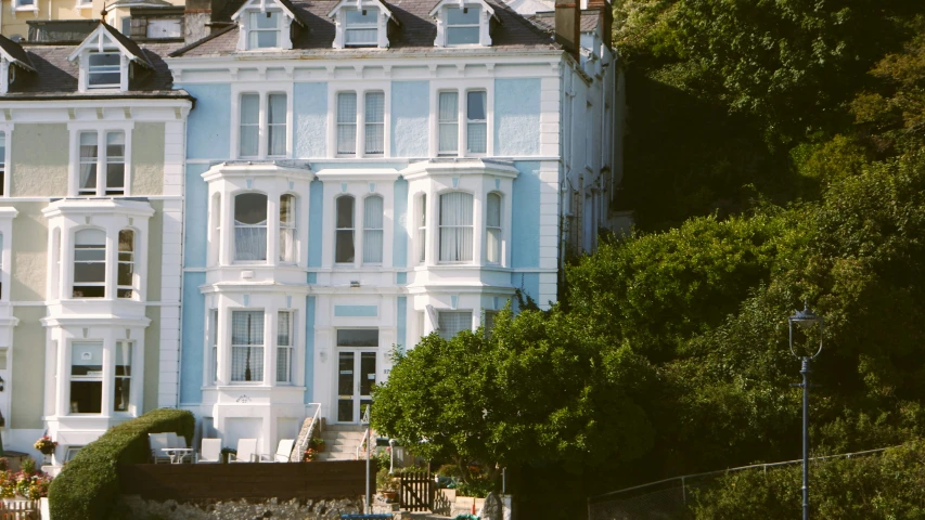 a large white building with a fence by it