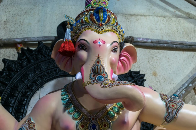 a statue of a small ganesh hindu riding on a motorcycle