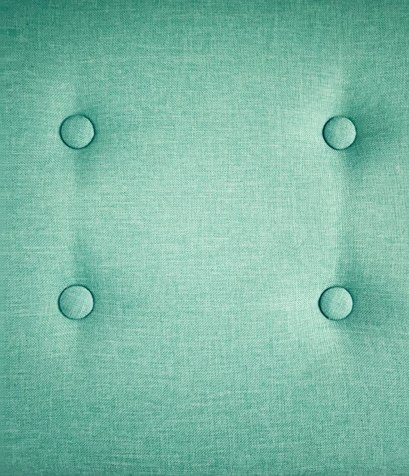 the background texture of a green material with several holes