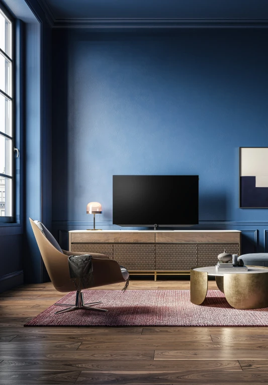 a blue room with a sofa, tv stand, and rug