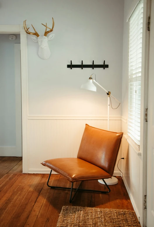 a modern chair sits alone in a white walled room