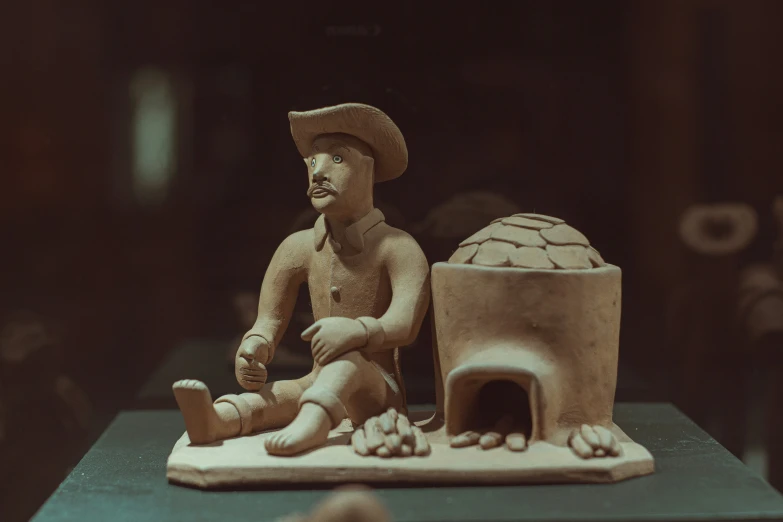 a wooden toy figure sitting on top of a desk