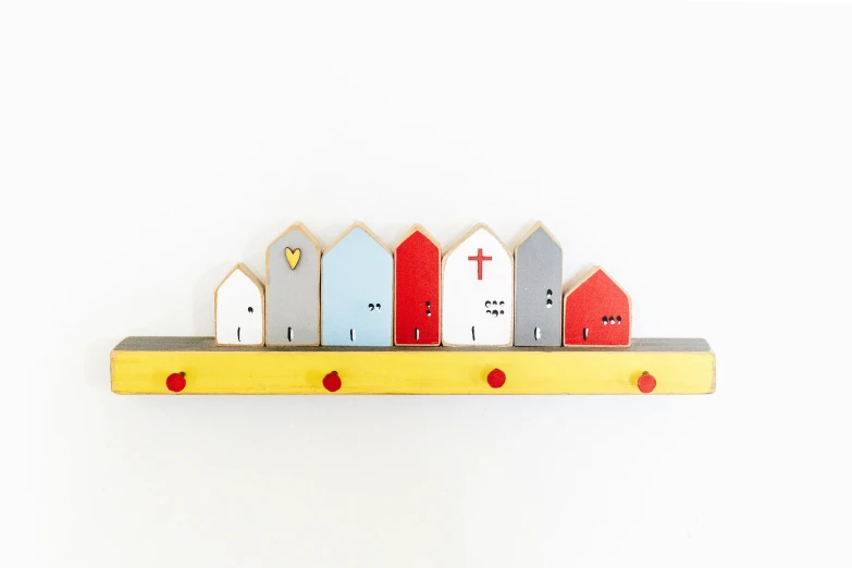 a wooden shelf topped with little buildings