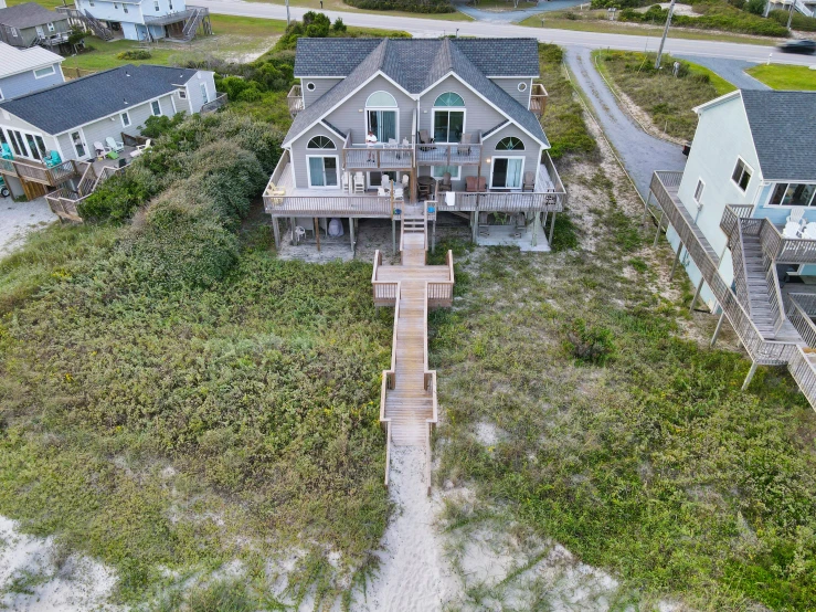 an aerial view of a beach house from the sky