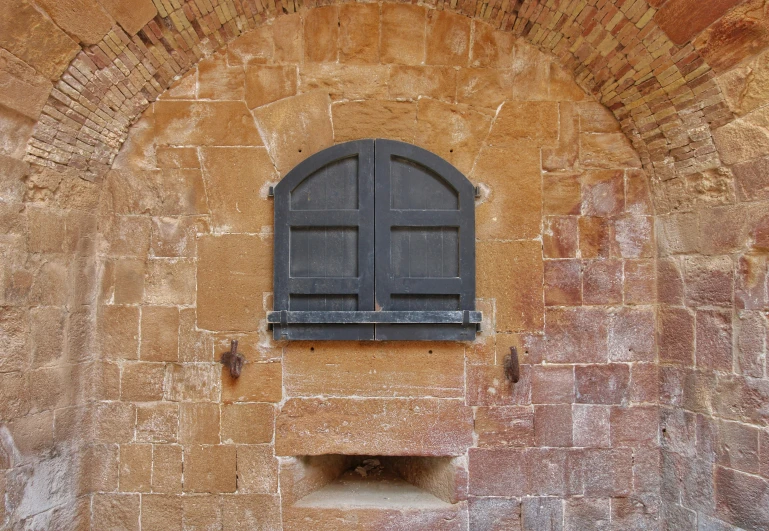 an old fashioned window and door with brick surround