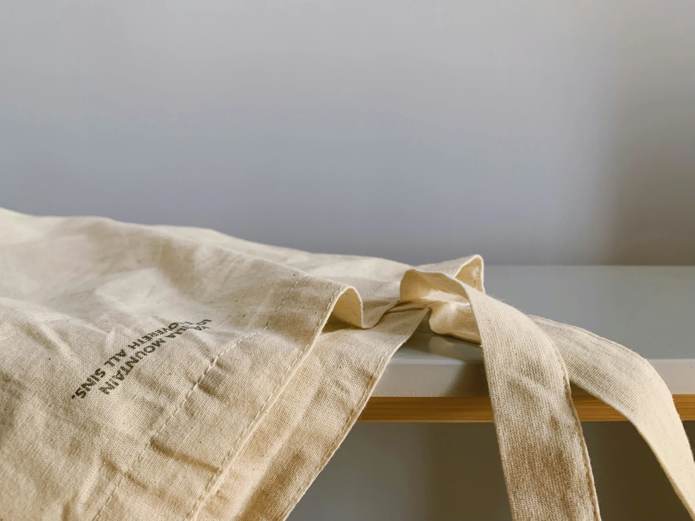 a beige bag with a ribbon tied around it