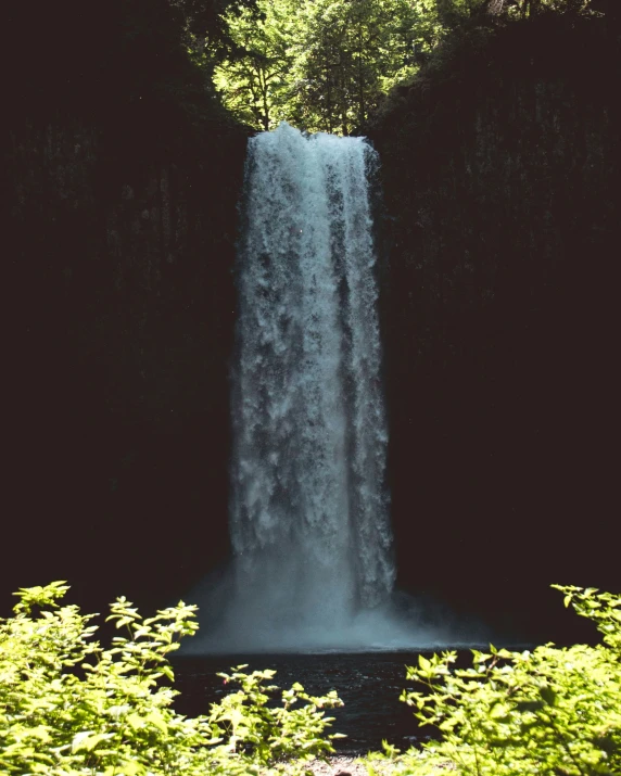 a large waterfall in a dark room