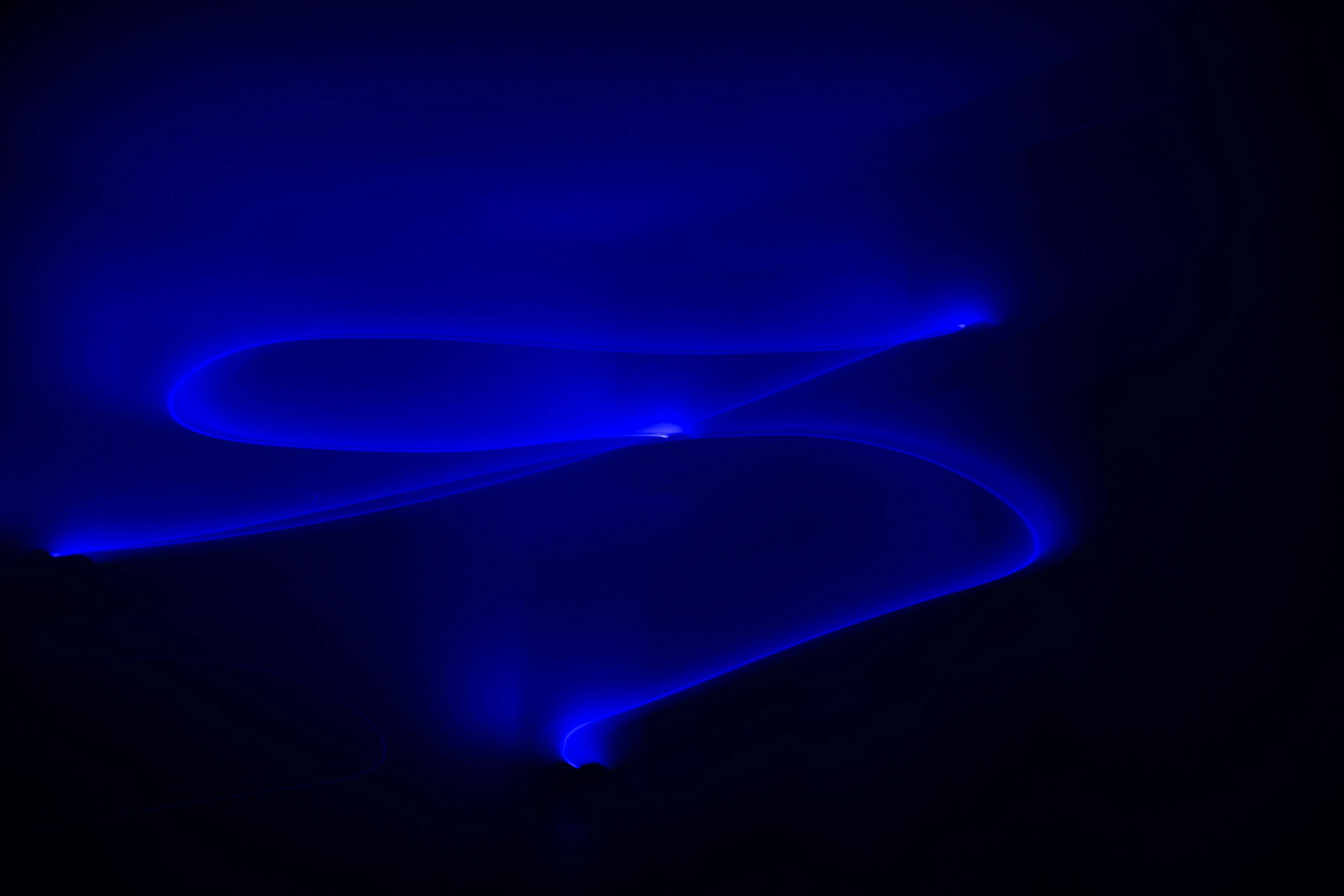 blue liquid swirls are arranged on black surface