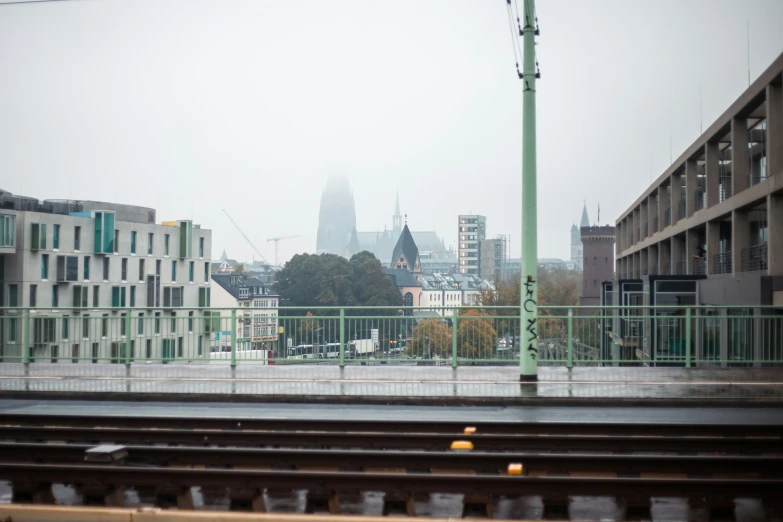 cityscape in the background as train tracks run past