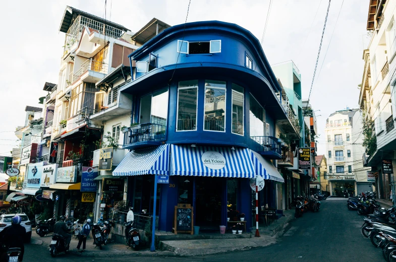 a corner of a street with people in front of buildings