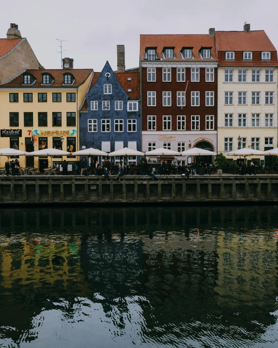 some buildings sitting next to the water