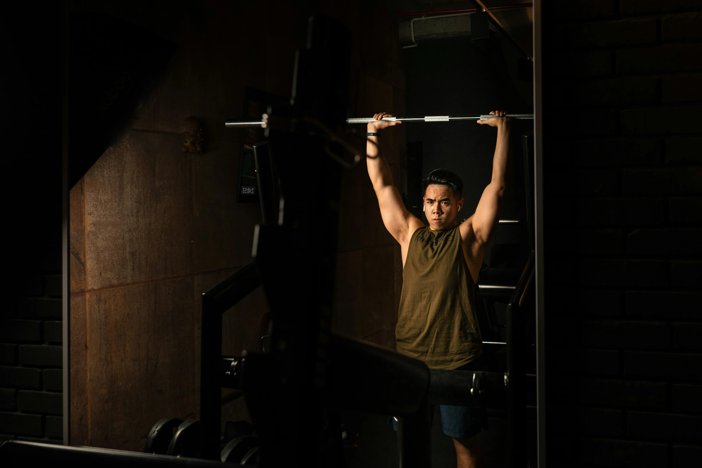 a man is exercising in a darkened gym