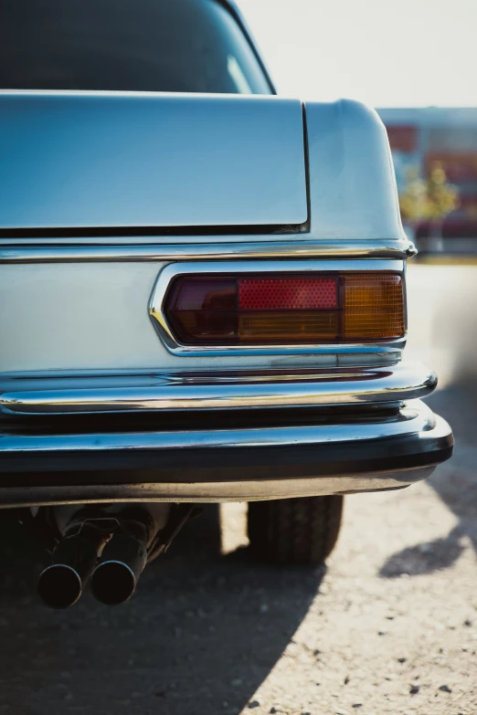 the tail lights on a silver car are all red