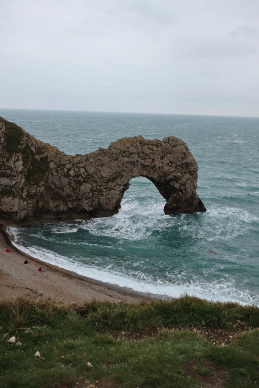 the coast has many rocks and waves coming in to it