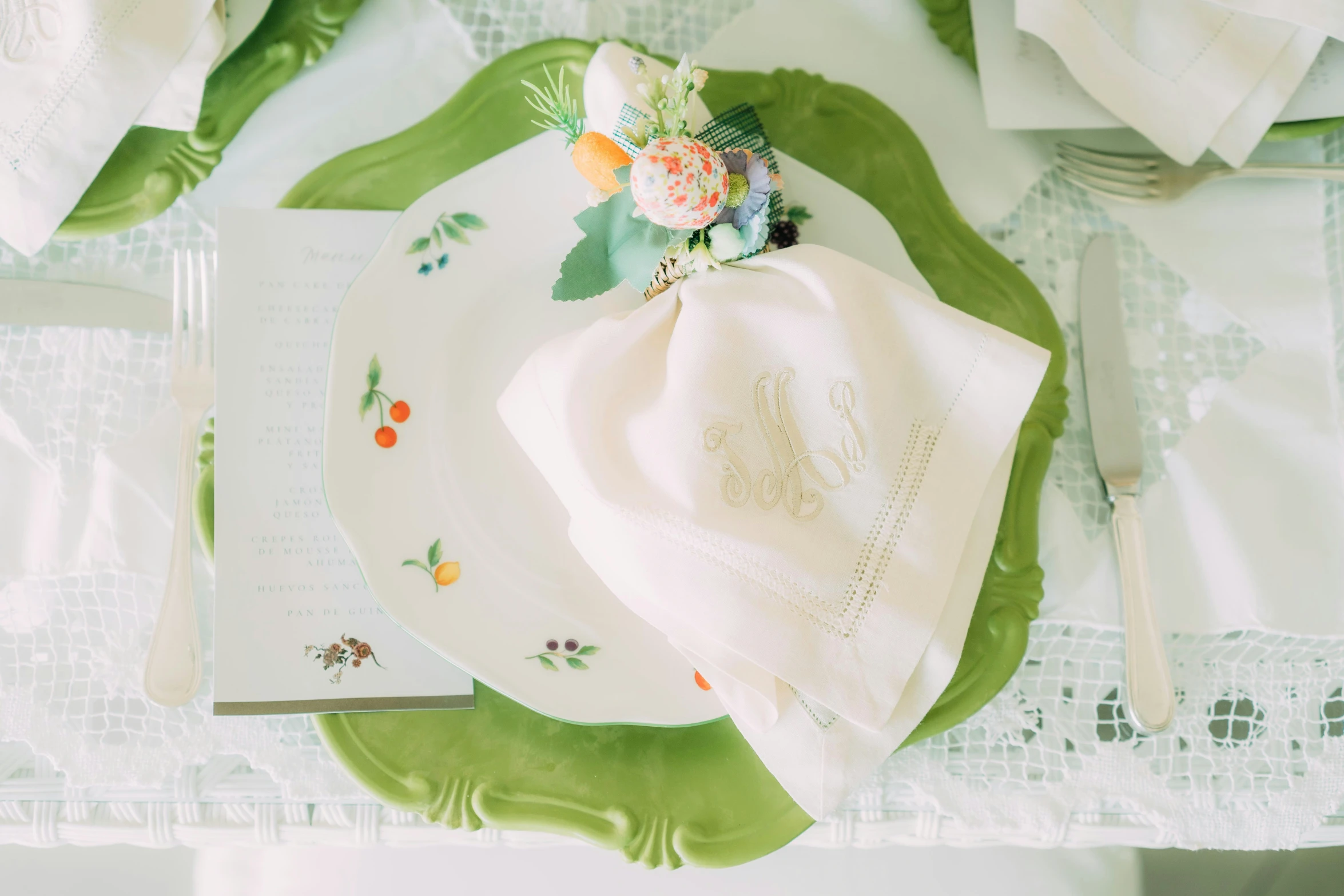 a table set with two sets of flowers