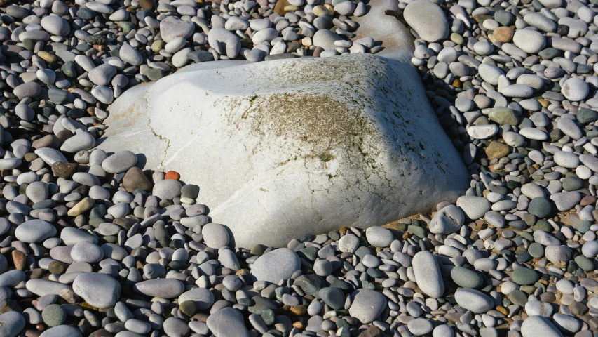 a white rock sitting on top of a pile of rocks