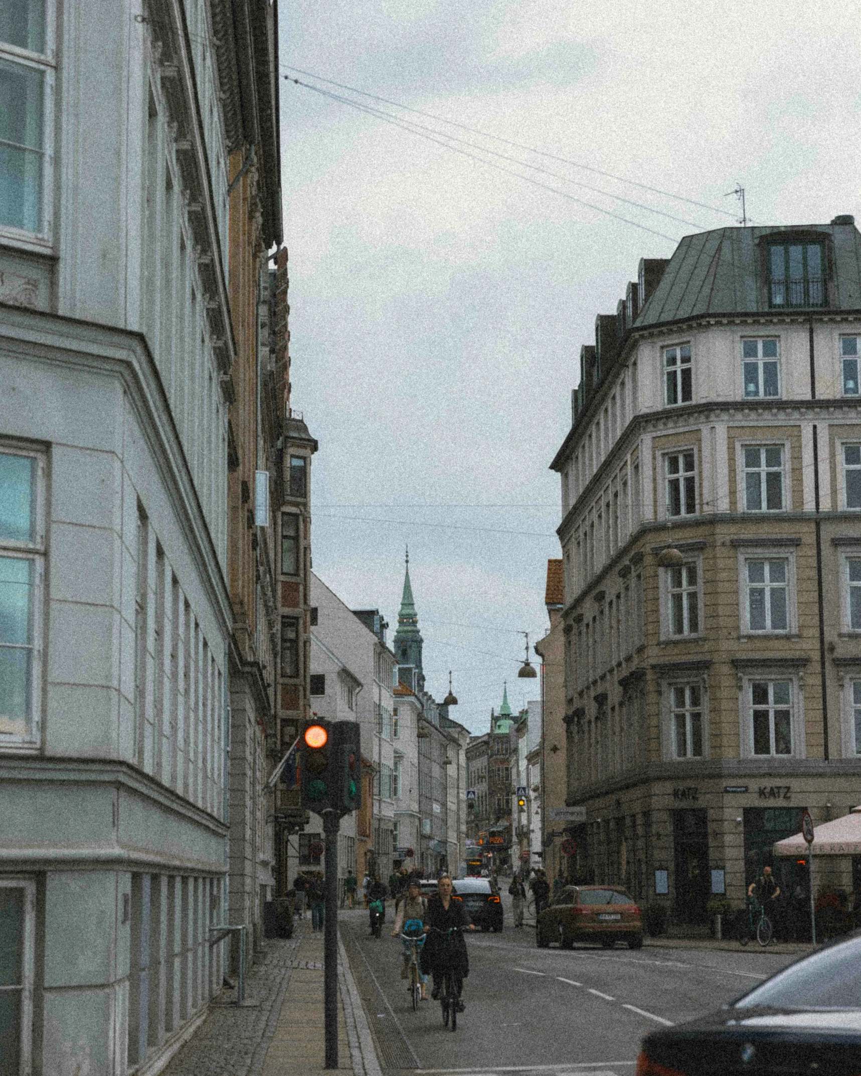 a busy street with many cars and pedestrians