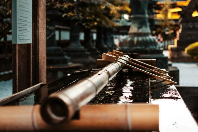 three large metal pipes resting in the water