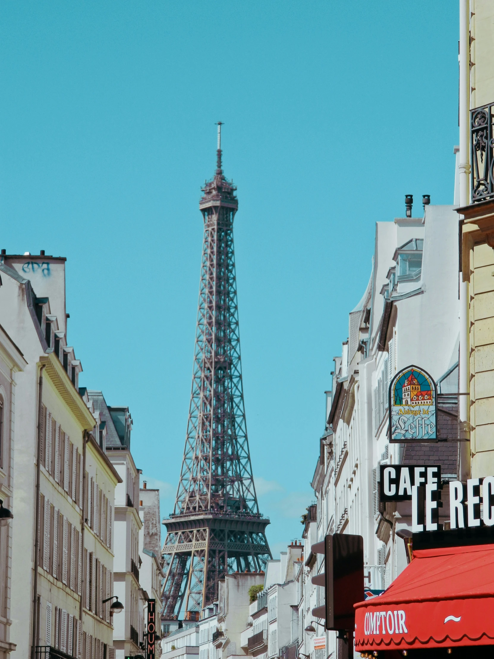 a group of people standing on the street below the eiffel tower