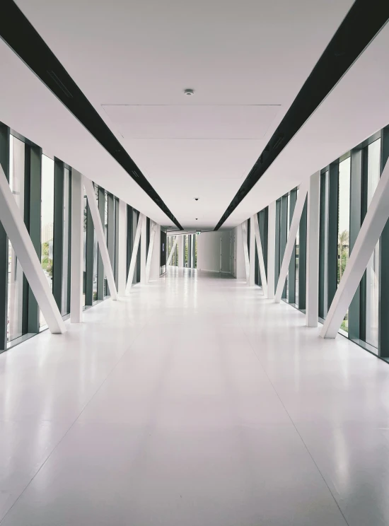 a long white hallway with black and white striped walls