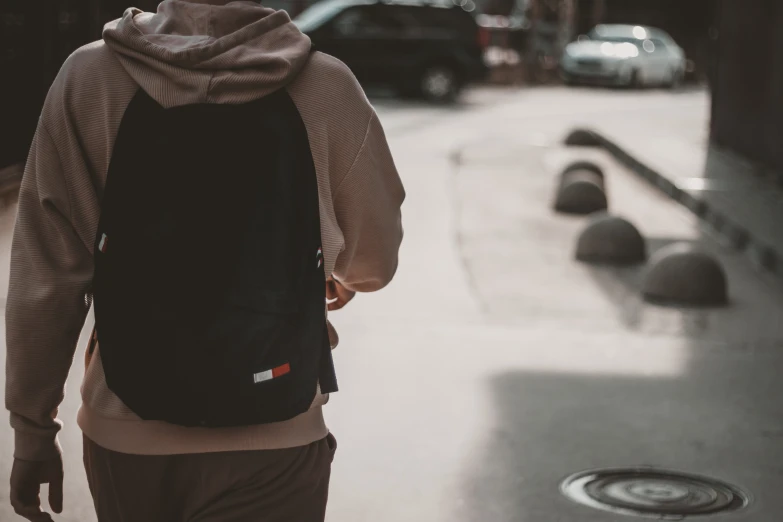 a person with a backpack walking down a street