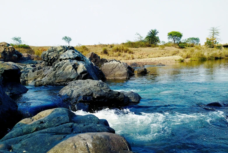 a body of water that is next to some rocks