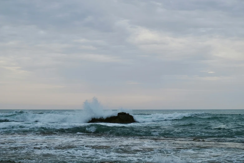 the view of a body of water and a rock on it