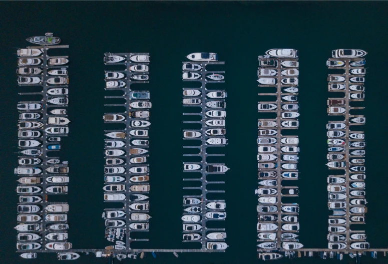multiple boats are shown near each other at night