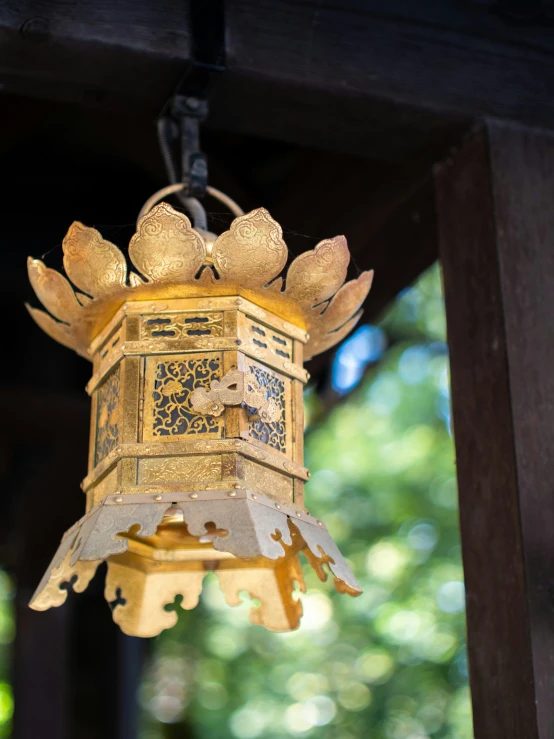 a close up of an open bell hanging from a building