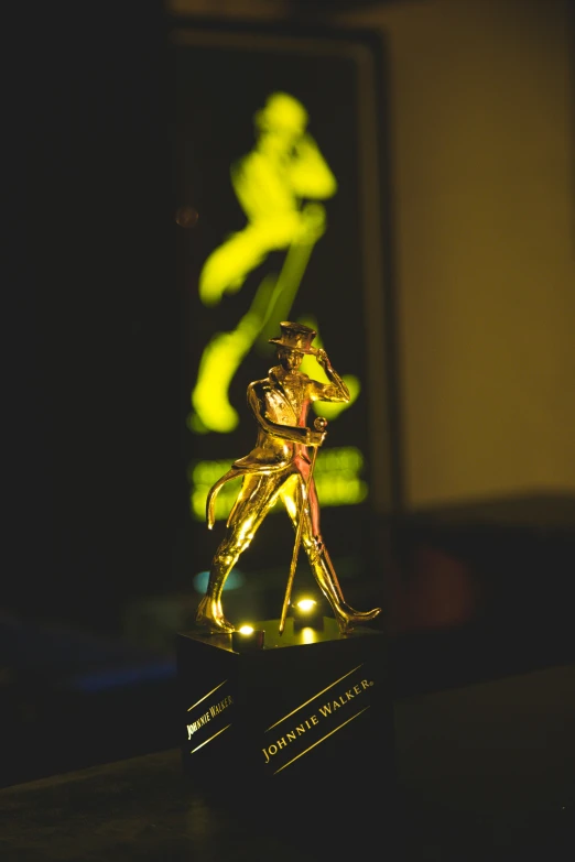 illuminated statue of running man on black base