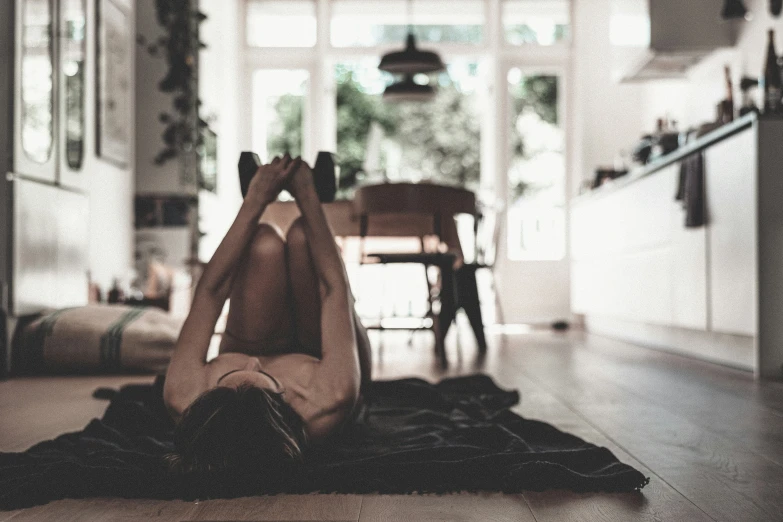 a woman sits on the floor in her dress